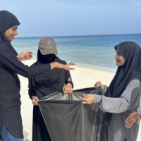teenagers holding a black bag