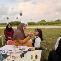 little female kid getting face painted