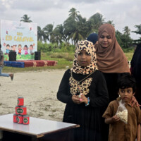 ކޭން ޝޫޓިން little girl playing "shoot the cans"