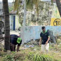 man staring at a pile of grass doing nothing