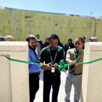 council president cutting the ribbon for an opening ceremony