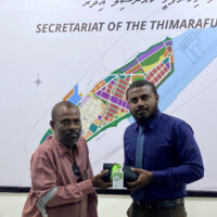 physically challenged man holding a cloth and card