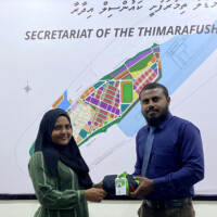 man giving something to a woman in green clothes