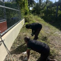 physically challenged man helping clean ground