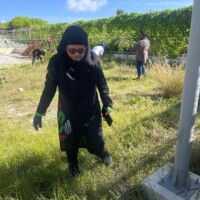 female with glasses staring at grass