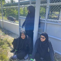 old ladies sitting near a pole
