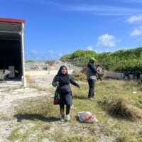 little girl running with a handful of grass
