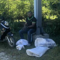 man sitting near bags