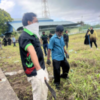 Angry man wearing a mask holding a sharp machete